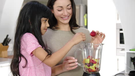 Mother-and-daughter-cooking-fruit-in-the-kitchen