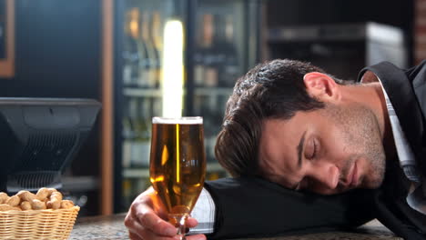 Businessman-with-beer-falling-asleep-