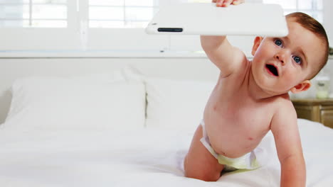 Cute-baby-holding-a-tablet-