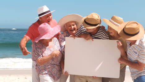 Group-of-mature-people-looking-a-white-sign