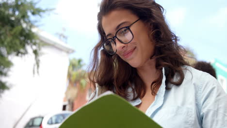 Beautiful-woman-smiling-while-reading-book