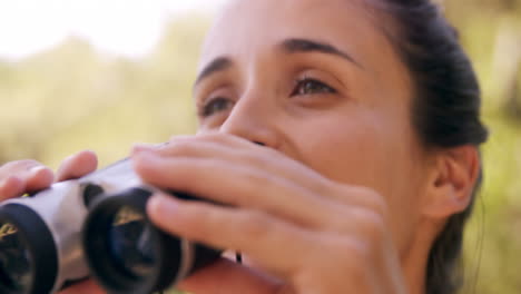 Young-woman-looking-through-binoculars