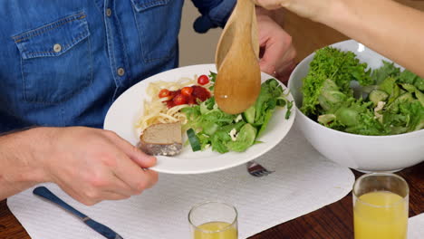 Family-having-dinner-together-in-kitchen