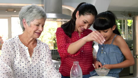 Little-girls,-grandma-and-his-mom-preparing-cake