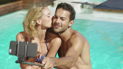 Attractive-couple-taking-selfie-by-the-pool