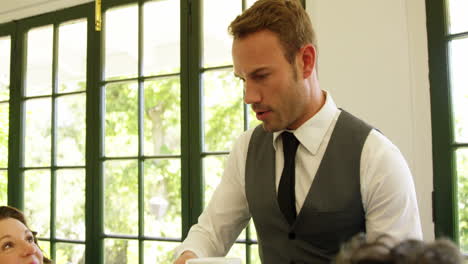 Waiter-serving-coffee-to-customers