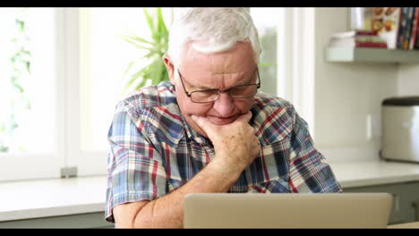 Worried-senior-man-using-laptop