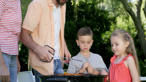 Cute-family-preparing-a-barbecue-in-the-garden-