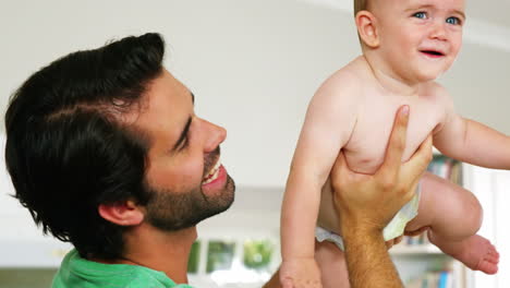 Happy-father-playing-with-his-baby-