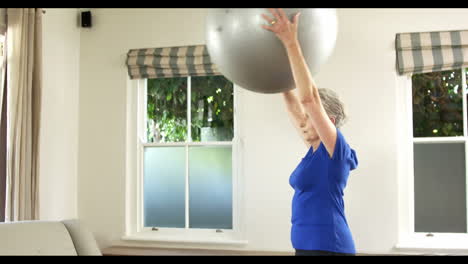 Senior-woman-lifting-exercise-ball