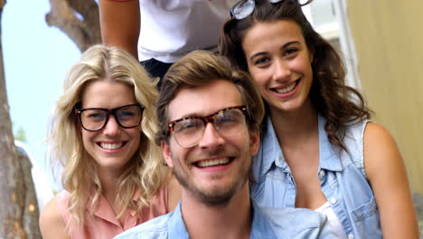 Friends-smiling-at-camera