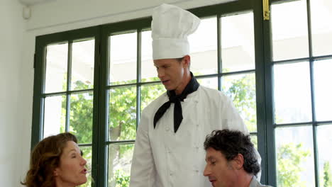 Chef-talking-with-cute-couple