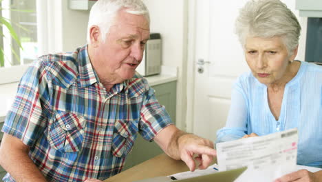 Old-couple-calculating-theirs-bills