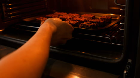 Woman-carrying-cookies-on-a-baking-sheet