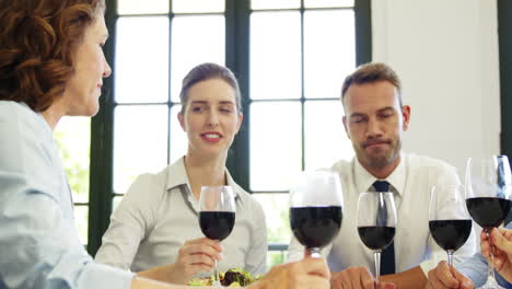 Business-people-toasting-together-with-red-wine-