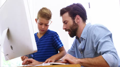 Father-and-son-using-computer-together