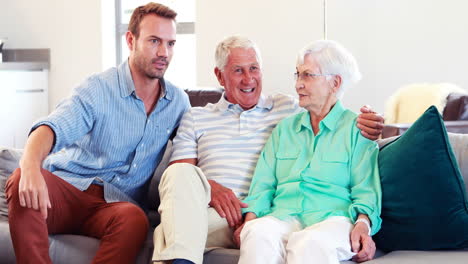 Man-and-smiling-senior-couple-discussing