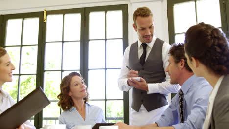 Waiter-taking-business-people-orders