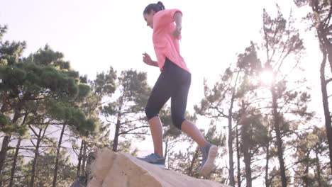 Sportswoman-raising-her-hands-after-climbing-rock