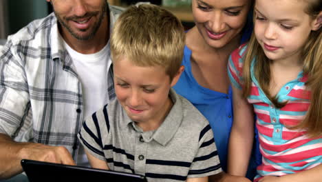 Eine-Glückliche-Familie-Entspannt-Auf-Dem-Sofa-Und-Benutzt-Ein-Tablet