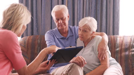 Female-nurse-and-senior-couple-interacting-with-each-other