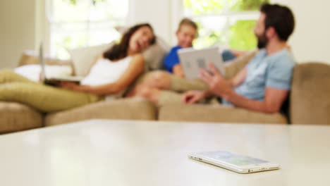 Smiling-family-looking-at-their-tablet-computer