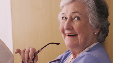 Senior-woman-removing-spectacles-and-smiling