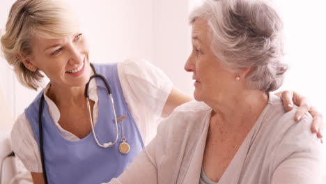 Female-doctor-consoling-to-a-senior-woman