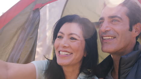 Smiling-couple-sitting-in-tent
