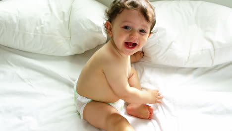 A-baby-boy-is-laughing-on-bed