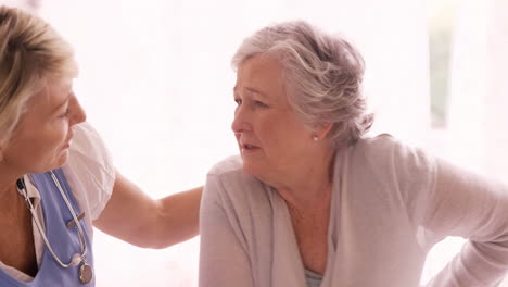 Female-doctor-consoling-to-a-senior-woman