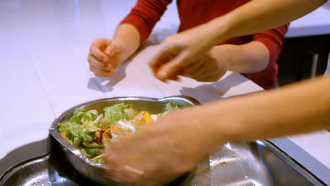 Close-up-of-woman-is-washing-lettuce-in-the-kitchen-