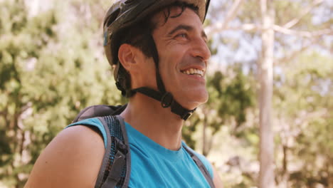 Smiling-cyclist-removing-his-sunglasses