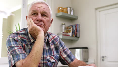 Sad-old-man-thinking-in-kitchen