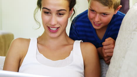 Smiling-women-and-her-son-looking-at-the-laptop