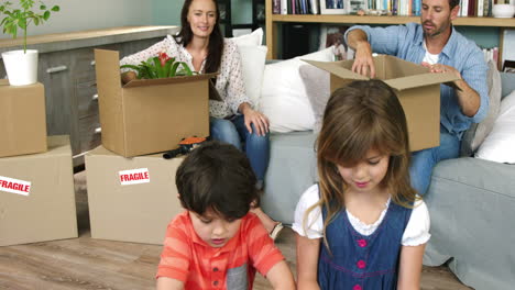 A-family-of-four-unpacking-boxes-