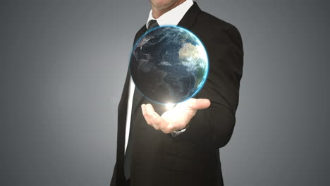 Businessman-holding-digital-generated-globe