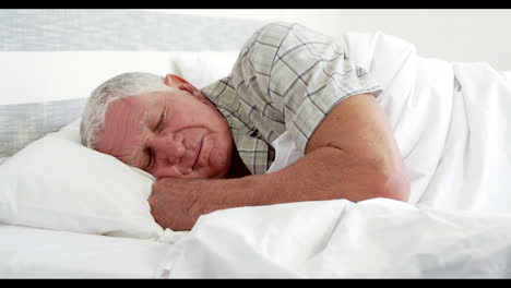 Senior-man-sleeping-in-bed
