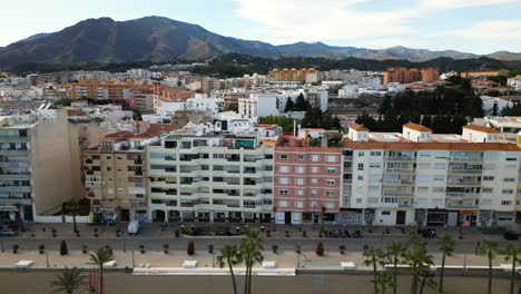 Coastal-apartment-buildings-of-Estepona-city,-aerial-side-fly-view