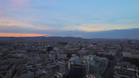 Establishing-rising-shot-of-Vienna-cityscape-after-sunset,-Austria-Capital