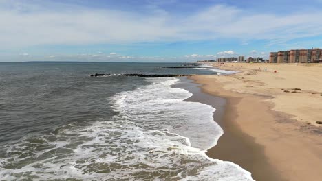 Una-Vista-Aérea-De-Las-Olas-Rompiendo-En-La-Playa-En-Cámara-Lenta