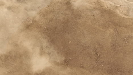 Close-up-view-of-a-dusty-ground-with-visible-movement-of-dust-particles