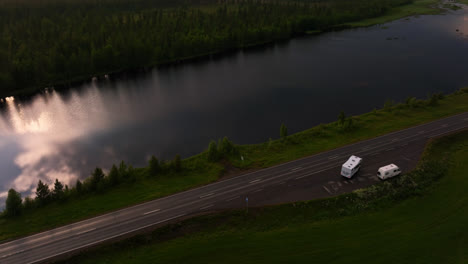 Aerial-view-around-camper-vans,-wild-camping-on-the-side-of-a-road-in-Lapland