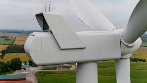 Close-up-of-Wind-Turbine-Nacelle-Housing-at-the-Rear-using-a-Drone-Panning-Around-the-Machine