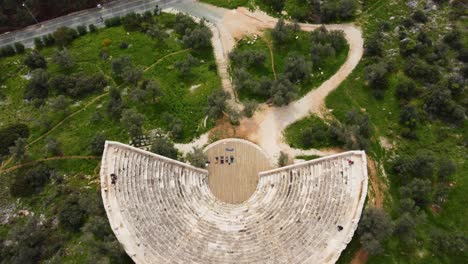 Birds-Eye-View-Looking-Down-from-1st-Century-BC-Ancient-Amphitheater-Overlooking-the-Mediterranean-Sea-To-Greek-Islands,-Antiphellos-Theatre's-Coastal-View,-in-Kas,-Turkey:-Turkish-Coast