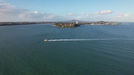 Speedboat-Cruising-At-Waitemata-Harbour-Leaving-Wake-Near-The-Stanley-Point,-Auckland,-New-Zealand