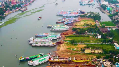 Ships-moored-for-repair-in-busy-docks-on-Buriganga-River,-Dhaka-City---Bangladesh