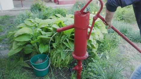 Person-Using-A-Hand-Water-Pump---Close-Up
