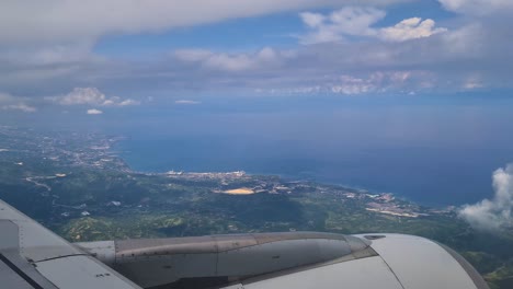 Airplane-Flying-Above-Cebu-City-and-Island-Coastline,-Philippines