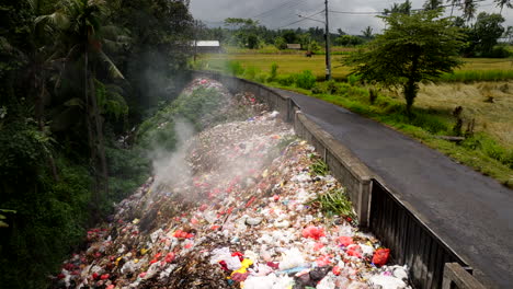 Smoldering-human-trash-heap-next-to-country-road-in-Bali